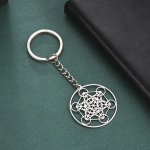 Macro detail of silver Metatron's Cube pendant on stainless steel keychain ring