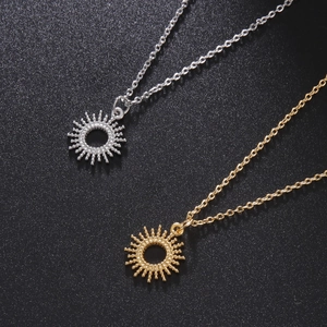 Minimalist stainless steel sun pendant necklace set in gold and silver finish on black surface