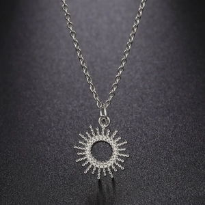Silver stainless steel necklace featuring a radiant sunburst pendant on a fine O-chain