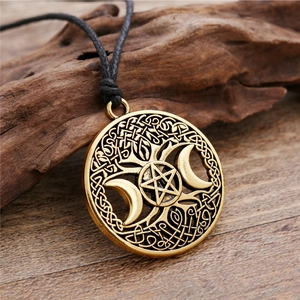 Gold Pentagram Triple Moon Goddess pendant necklace with Celtic knot details on wood