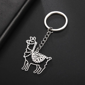 Polished silver alpaca keychain featuring an intricate hollow design on dark leather background