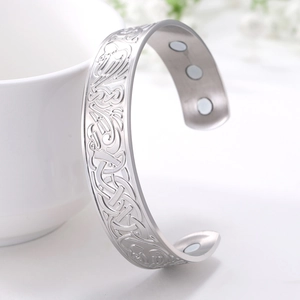 Detail view of Celtic knot engraving and embedded magnets on stainless steel bracelet
