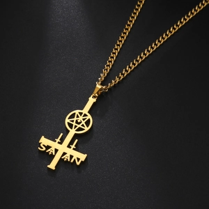 Macro detail of golden stainless steel inverted cross pendant with Satan engraving
