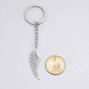 Punk style stainless steel keychain with detailed hollow wing pendant and silver finish