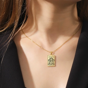 Gold stainless steel Strength tarot card necklace featuring a lion head and infinity symbol