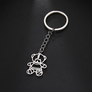 Minimalist silver metal keychain with creative hollow bear pendant and chain on black background