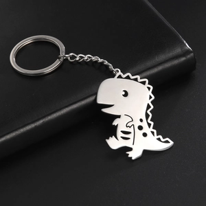 Detailed close-up of a hollow dinosaur metal keychain in silver stainless steel finish