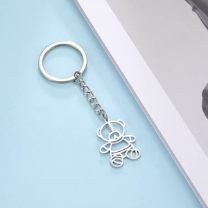 Detailed close-up of hollow bear pendant keychain with silver metal chain and ring
