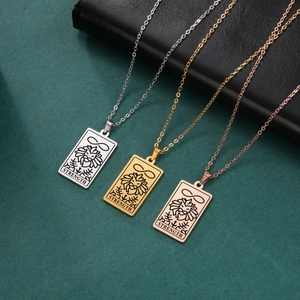 Close-up of Strength tarot card pendants in silver, gold, and rose gold stainless steel