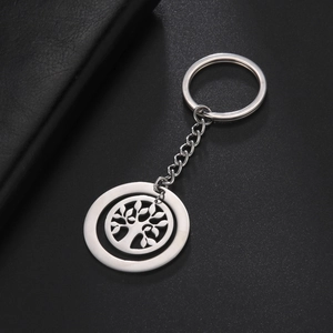 Macro detail of silver stainless steel key ring with hollowed tree of life pendant charm