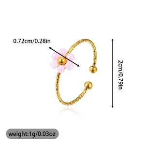 Detail view showing dimensions of a gold textured ring with a pink beaded flower motif