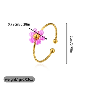 Detailed view of adjustable gold ring with pink flower bead and diamond-cut texture