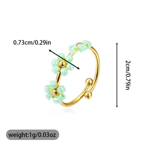 Detail view of adjustable gold ring with three green floral charms and dimensions