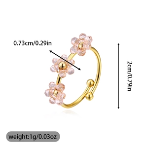 Macro shot showing dimensions of adjustable gold ring with small pink floral beads