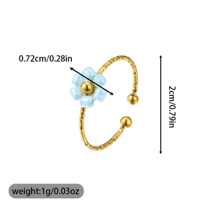 Detail view of adjustable gold ring with light blue beaded flower and dimension labels