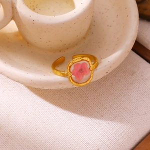 Detail showing pink dried flower embedded in gold adjustable resin ring for women