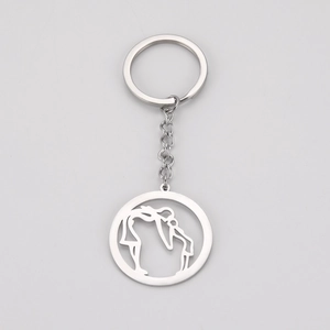 Minimalist silver stainless steel keychain featuring a circular mother and child pendant