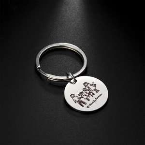 Detailed macro view of laser engraved family silhouette and heart on polished steel keychain