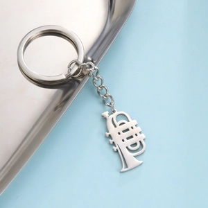 Creative stainless steel trumpet keychain with musical instrument pendant on silver tray