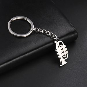 Detailed close-up of a silver trumpet-shaped keychain with high-polished stainless steel finish