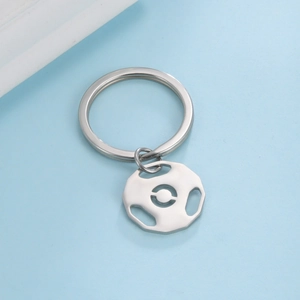Detail of silver stainless steel keychain featuring a barbell weight plate pendant