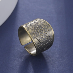 Detailed view of vintage bronze hexagon ring with sacred geometry engraving and open band