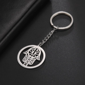 Detail view of silver stainless steel Hamsa Hand keychain with intricate hollow patterns