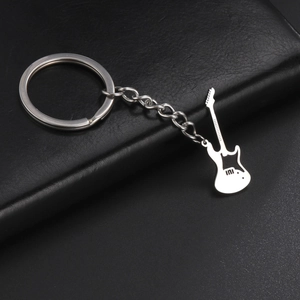 Detailed macro of a silver guitar pendant keychain made of polished stainless steel