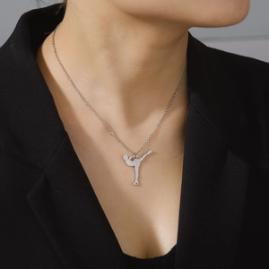 Close-up of figure skater silhouette pendant on silver 304 stainless steel chain