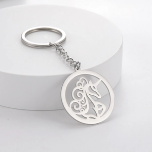 Minimalist silver stainless steel keychain with hollow unicorn pendant on round stage