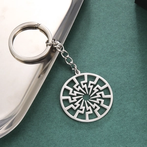 Polished stainless steel keychain featuring a hollow-out circular sunburst pendant