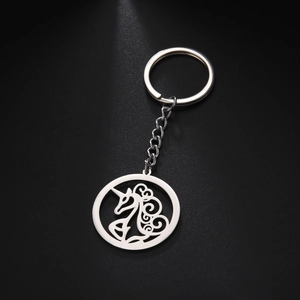 Close-up of a silver hollow unicorn pendant keychain with polished stainless steel finish