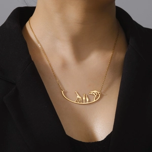 Gold stainless steel giraffe and tree pendant necklace on professional model clothing