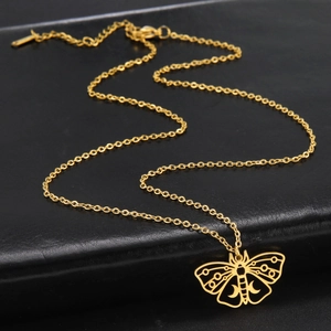 Detailed macro of gold butterfly moth pendant with hollow moon patterns and lobster clasp