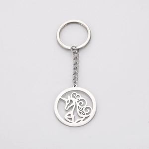 Detail view of a polished stainless steel keychain featuring a hollow unicorn pendant charm