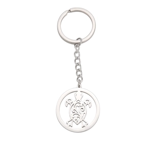 Polished stainless steel keychain with hollow sea turtle pendant on white background