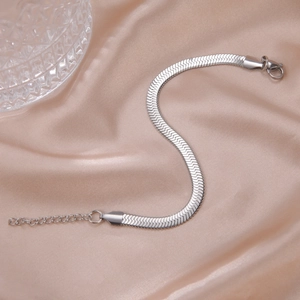 Detailed view of silver herringbone flat chain bracelet with lobster clasp and extender