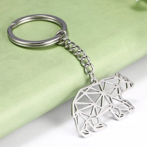 Close-up of geometric hollow polar bear keychain made of polished stainless steel