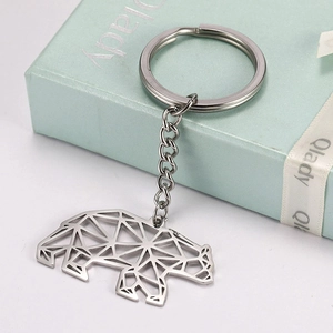 Detail of silver stainless steel keychain featuring a geometric hollow bear pendant design