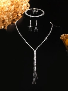 Detailed view of silver jewelry set featuring black pear-cut gems and rhinestones