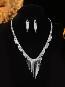 Detailed view of silver bridal jewelry set with sparkling rhinestones and fringe tassel design