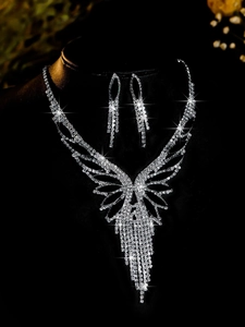 Detailed view of bridal jewelry set with sparkling zircon butterfly tassels and earrings