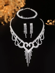 Detailed close-up of bridal jewelry set with sparkling tassels and heart necklace detail