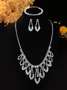 Detailed macro view of bridal jewelry set with tiered teardrop pendants and rhinestones
