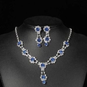 Macro detail of bridal jewelry set with navy blue round stones and silver halo crystals