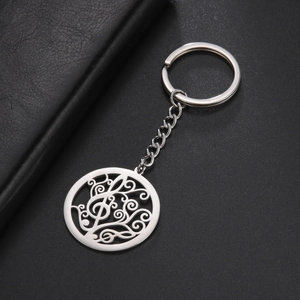 Detail of music note treble clef engraving on a silver stainless steel keychain
