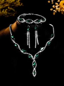 Close-up of emerald marquise-cut necklace and earrings set with crystal rhinestones