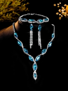Close-up of blue marquise-cut zircon necklace, earrings and bracelet set for brides