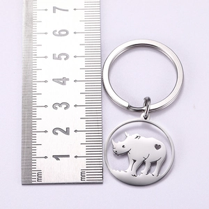 Polished stainless steel rhinoceros keychain featuring heart cutout and circular keyring