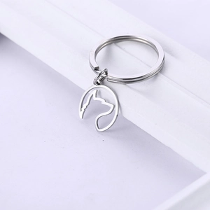 Porte-clés minimaliste en acier inoxydable avec pendentif tête de chien ajouré sur blanc